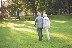A senior couple taking a walk through the park