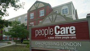 Close-up of peopleCare Oakcrossing Long Term Care sign in front of building