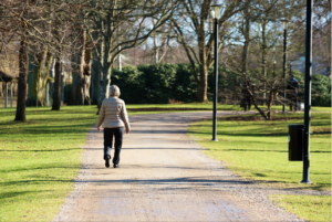 A senior woman taking a walk through the park