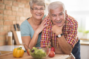 A senior couple smiling in the kitchen