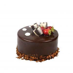 A small chocolate cake with strawberries on top