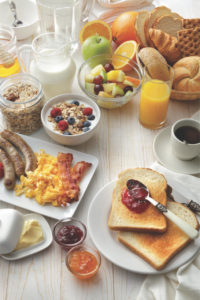 A variety of prepared breakfast foods on a table