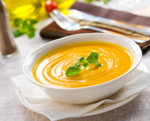 A bowl of butternut squash soup on a table
