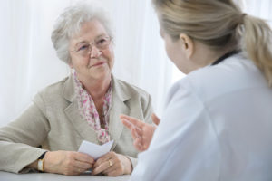 A senior woman speaking with her doctor