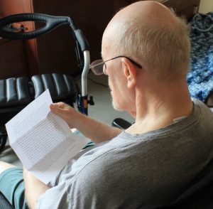 Long-term care resident reading letter written by university students