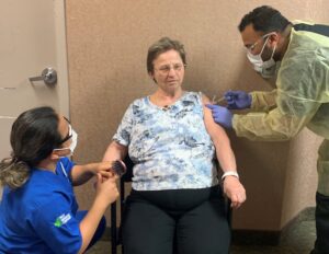A long-term care home resident receiving COVID-19 vaccine