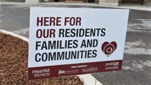 Lawn sign that says here for our residents families and communities