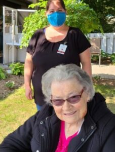 peopleCare LTC resident and designated family caregiver posing for a photo together outside