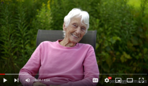 Thumbnail of peopleCare Annual Resident Retreat video showing a smiling woman sitting in nature