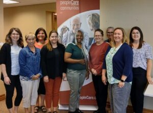 peopleCare Clinical Leaders pose with trainer Jayne Harvey