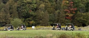 Golfers in golf carts on a beautiful fall day