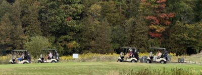 Golfers in golf carts on a beautiful fall day